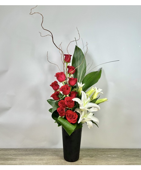 red roses and lilies in a dramatic modern arrangement