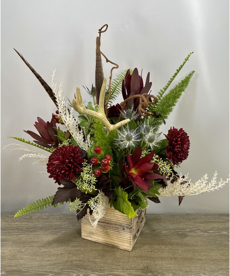 holiday flowers in vibrant reds with antler accent